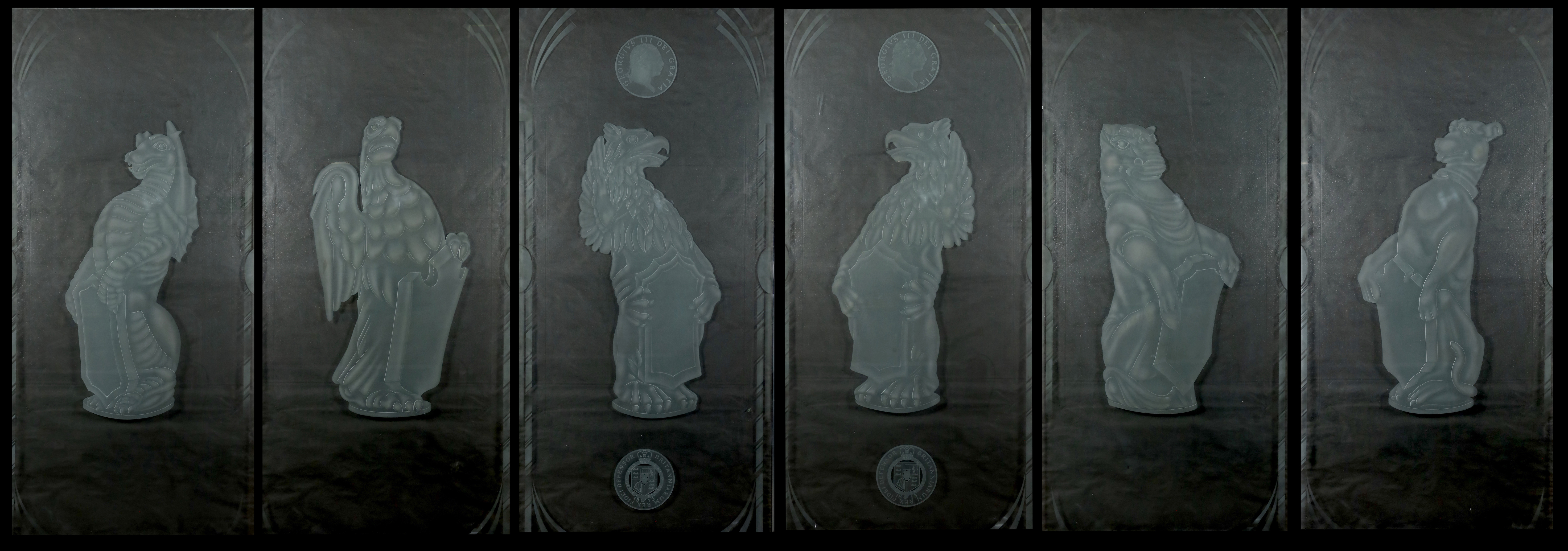 A set of six large cut and etched glass door panels